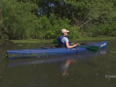 Image of woman in a canoe on a lake.