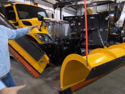 Image of man in front of snow plow.