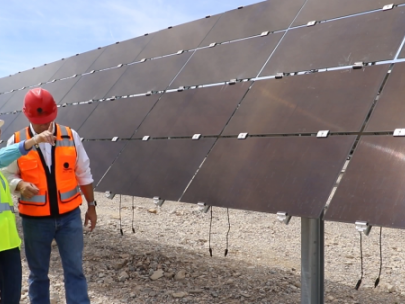 Image of workers discussing solar panels.