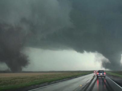 Image of tornadoes along a country road.