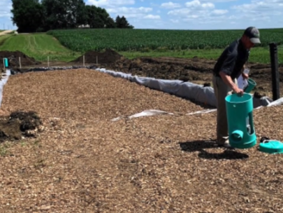 Image of person working on woodchip bioreactor.