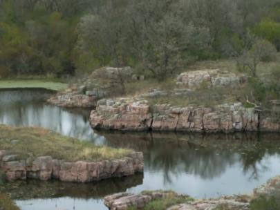 Image of rock outcrops along water.