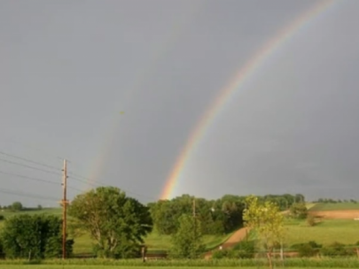 Image of a rainbow over a field.