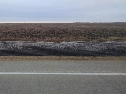 Snow near a tilled field.