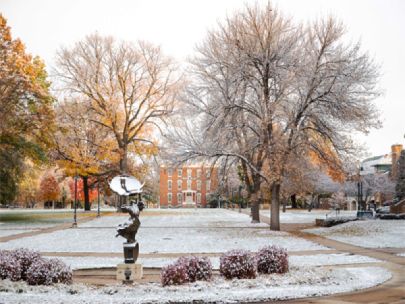 View of Wartburg College's campus in the winter. A statue can be seen in the foreground.